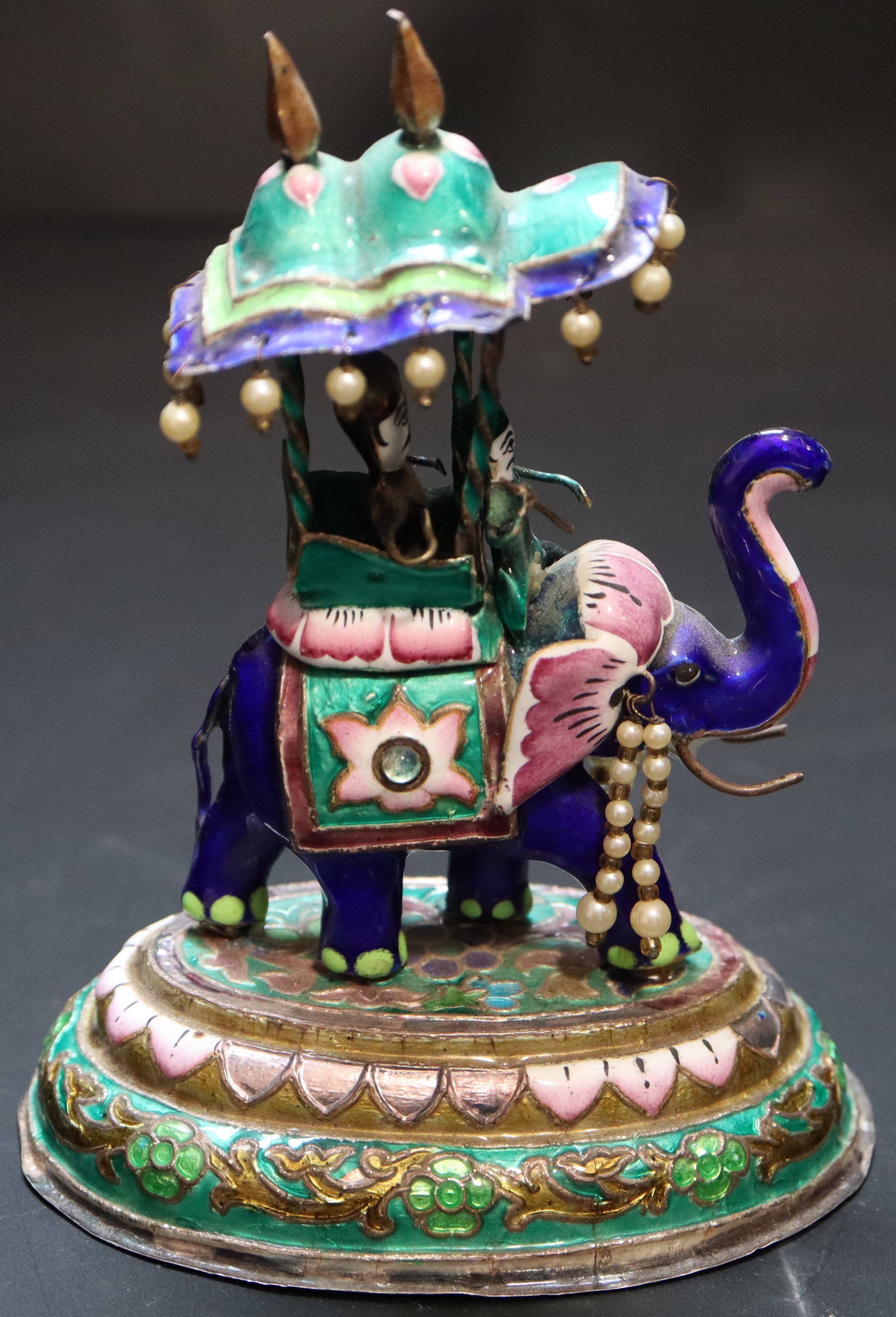 An Indian enamelled white metal miniature elephant with howdah, height 13.7cm, gross 295 grams.